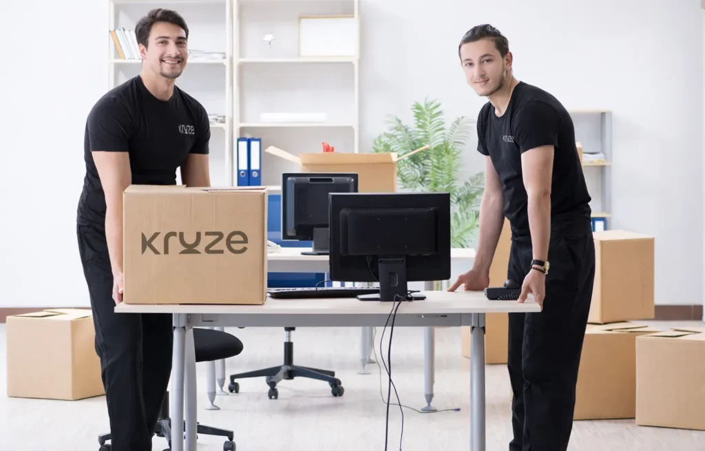 Kruze staff moving office equipment and packed boxes