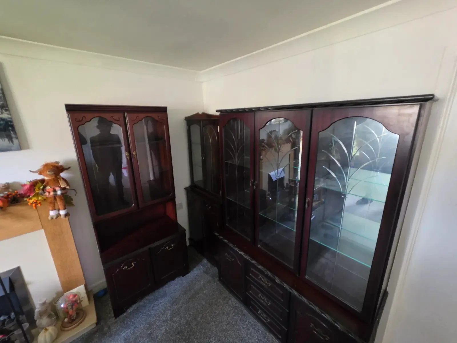 Before: large dark wood display cabinets in a living room, furniture removal by Kruze, Shipley BD18