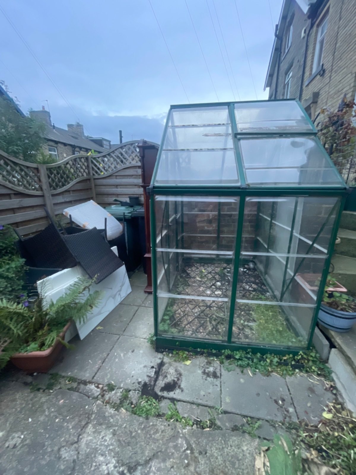 Before: greenhouse and old garden furniture waiting for collection by Kruze, Bradford BD12